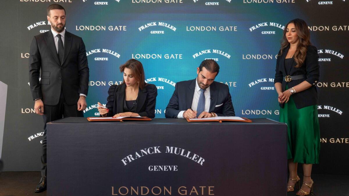 Eman Taha, CEO of London Gate, and Erol Baliyan, Managing Director of Franck Muller, sign the agreement. — Supplied photo