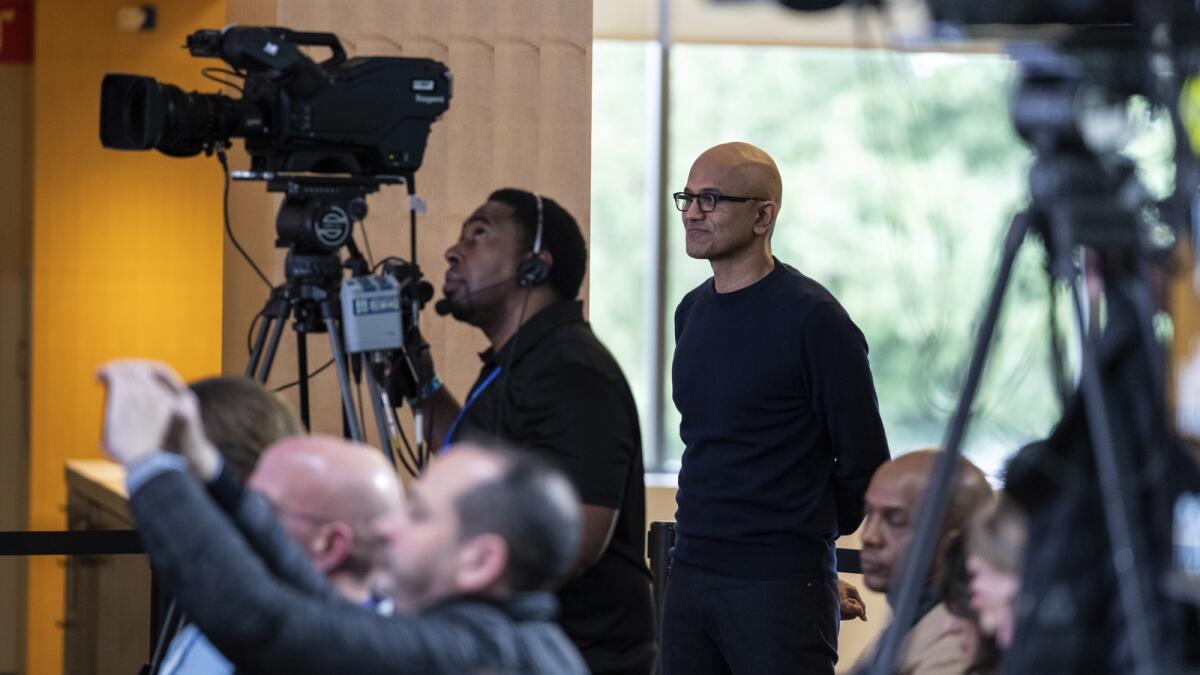 Microsoft CEO Satya Nadella watches a presentation introducing the integration of the Bing search engine and Edge browser with OpenAI in Redmond. — AP file